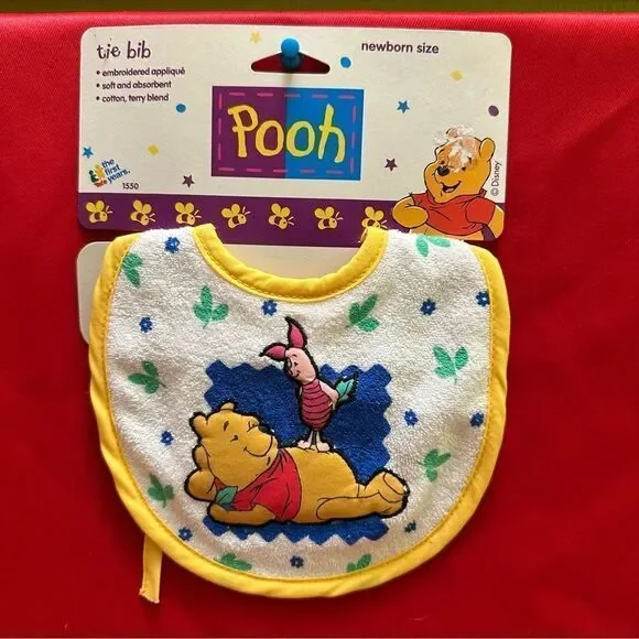 The first years Pooh Tie Bib Newborn