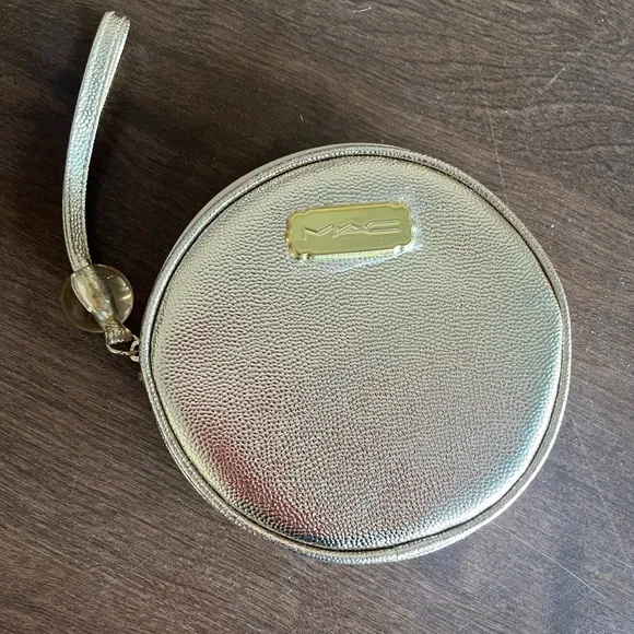 MAC Cosmetics shimmering gold round‎ wrist pouch