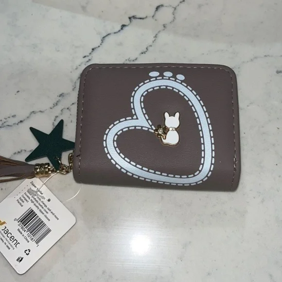 Wallet . Zipper wallet 4 1/2 inches by 3 1/2 inches . NWT