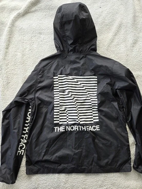 The North Face Optical Cyclone windbreaker features a distinctive optical illusi