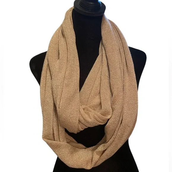 Pale pink infinity scarf with‎ gold threads.