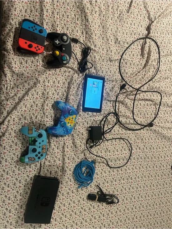 Nintendo Switch with Neon Red/Blue Joy‑Con and Blue Themed Controllers
