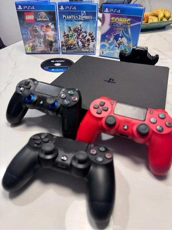 Sony PS4 Slim with 2 Black and 1 Red DualShock Controllers and 4 Games