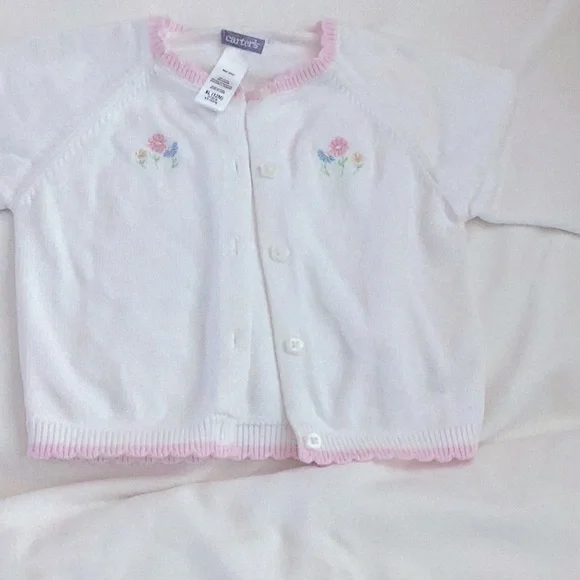 Carter’s white sweater with pink trim on neck, sleeve and hem. 12 months