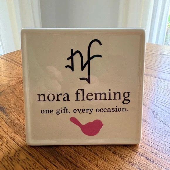 Nora Fleming Sign - White w/Pink bird “one gift. every occasion.”Retailer only