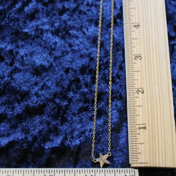 Silver toned necklace with star