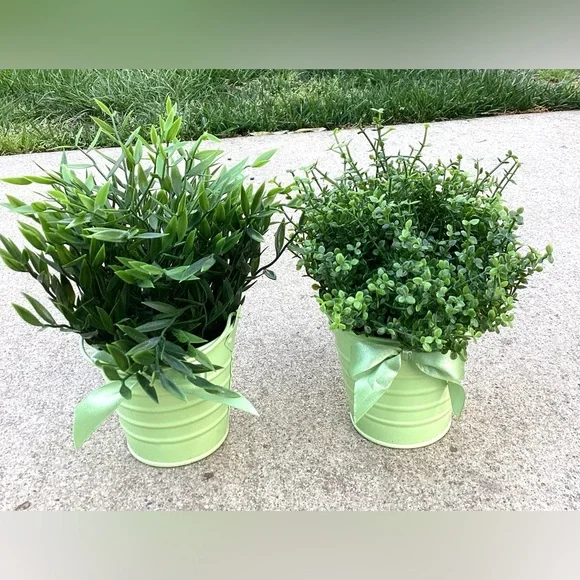 2 decorative faux green plants with pretty pots