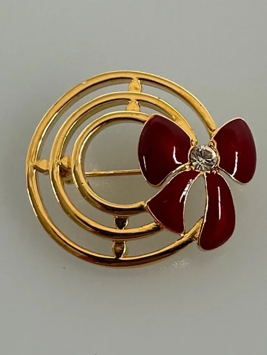 Gold-Tone Brooch with Red Enamel Bow and Crystal Accent