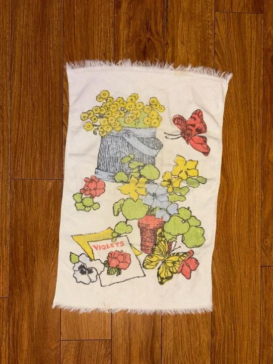 Vintage 1970s hand towel with a floral design and butterflies