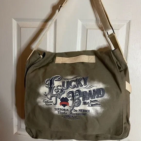 Lucky Brand large canvas olive green messenger bag with adjustable beige strap.