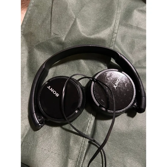 These are a pair of black Sony on-ear wired headphones. The earcups feature the