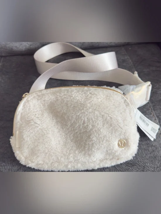 lululemon athletica Cream Faux Shearling Crossbody Pouch with Gold Logo