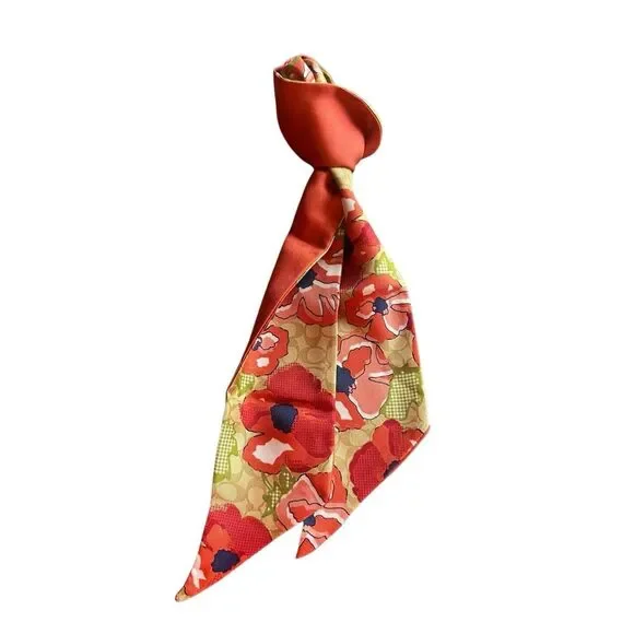 COACH silk twilly scarf orange poppy and tan signature Cs background