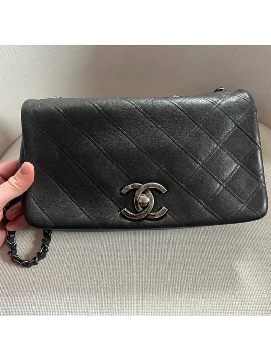 CHANEL Black Quilted Lambskin Shoulder Bag with Silver CC Lock.