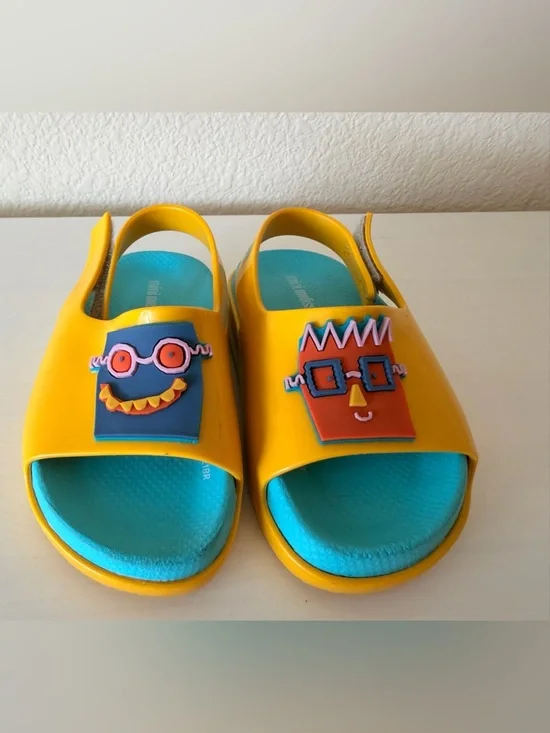 Mini Melissa Unisex Yellow Sandals with Blue Insole and robot characters.