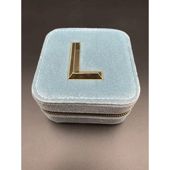 Small blue velvet jewelry box with a zipper