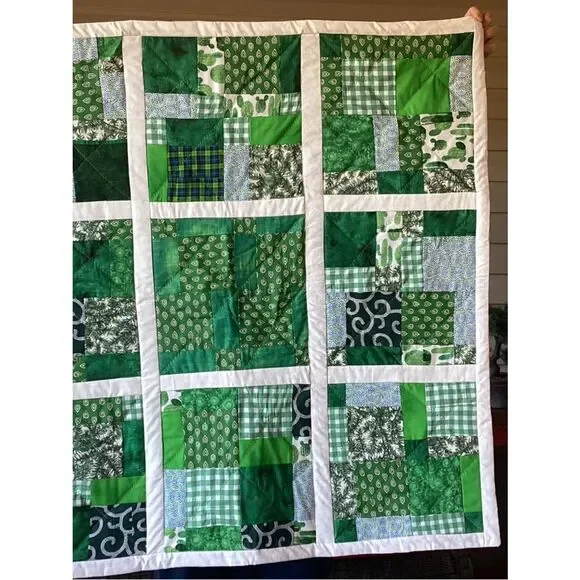 New without tags. Medley of Green Fabrics with White Borders Quilt