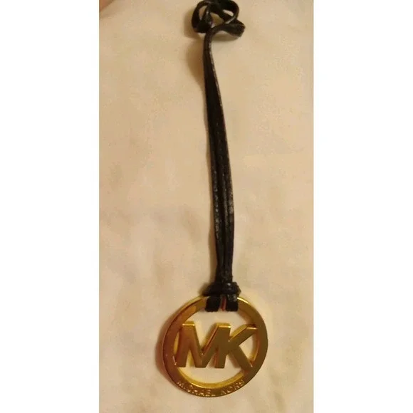 Michael Kors Gold Tone MK Logo Charm Hang Tag Luggage color Leather Strap