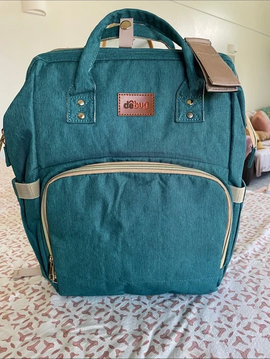 DEBUG Convertable Diaper Bag With Portable Changing Table. Teal color.