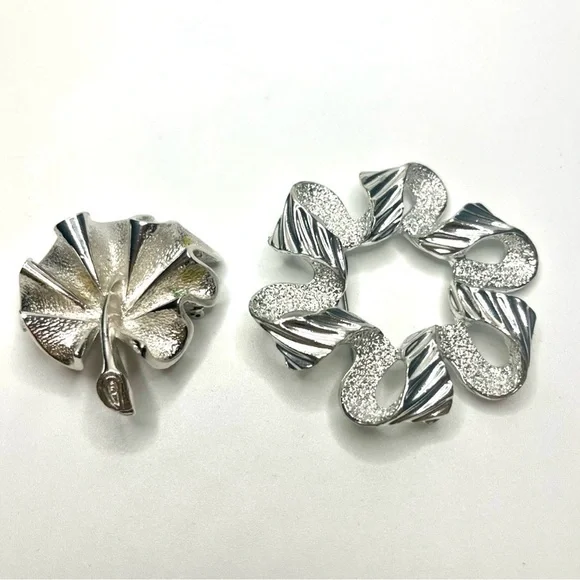 Two Elegant Silver tone Sarah Coventry brooches.
