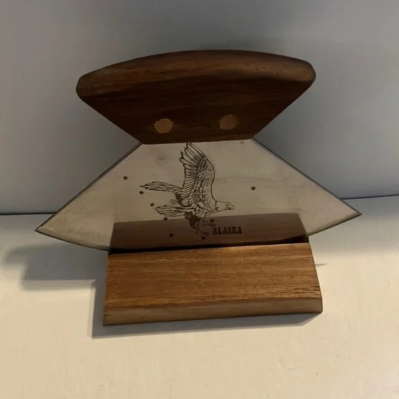 Alaskan Ulu knife with a walnut wood handle and a stand.‎