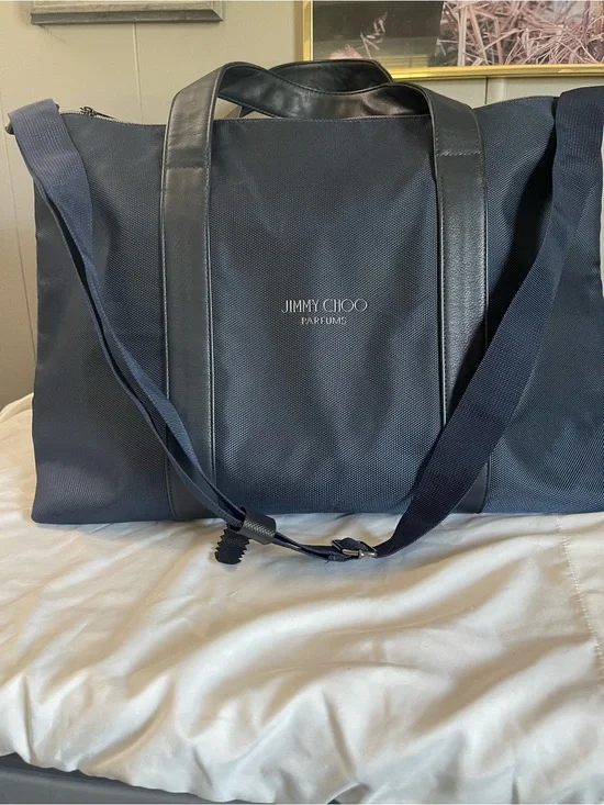 Large navy travel duffel from Jimmy Choo Parfums Durable fabric with leather