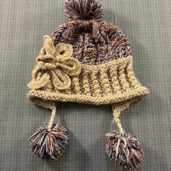 Multicolored knitted hat with pom poms