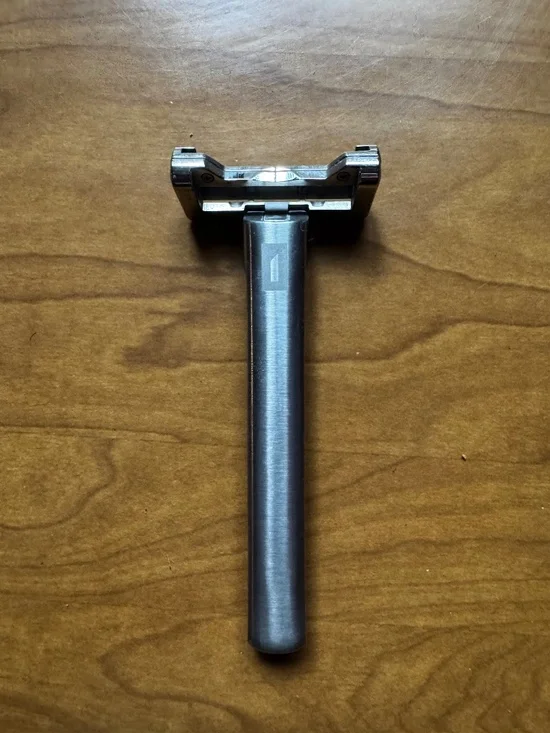 OneBlade razor with leather case, metal stand, and blades