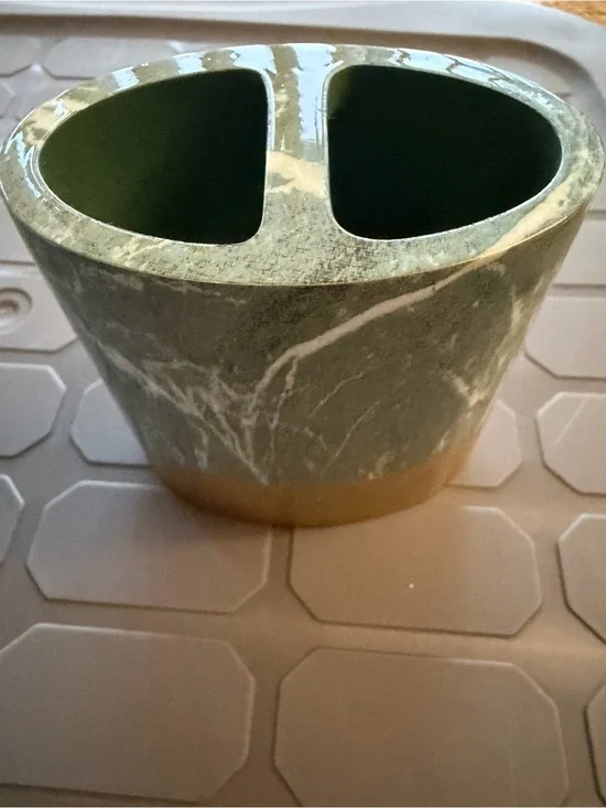 Toothbrush holder green marble pattern with gold colored base.