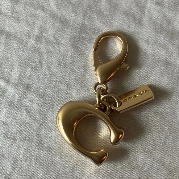 Coach: Metallic Gold Tone Key Holder Charm