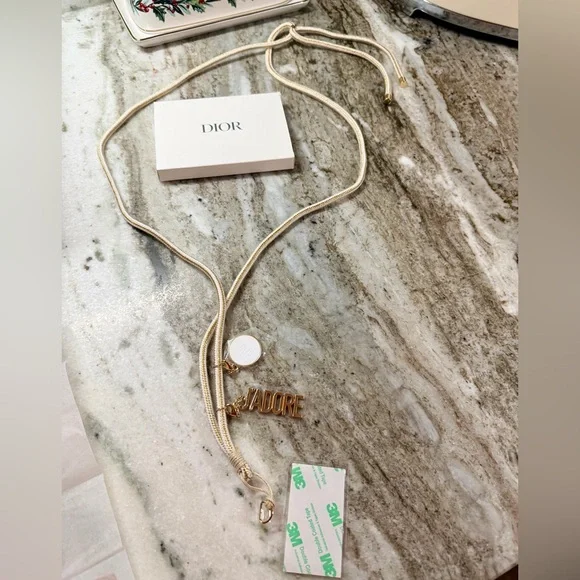 Dior J’adore Phone Strap with Charms. Measures 22” long. New in Box. Sealed