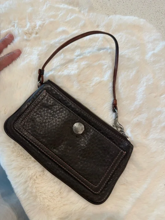 Coach Dark Brown Pebbled Leather Wristlet( It's stained on the inside.)