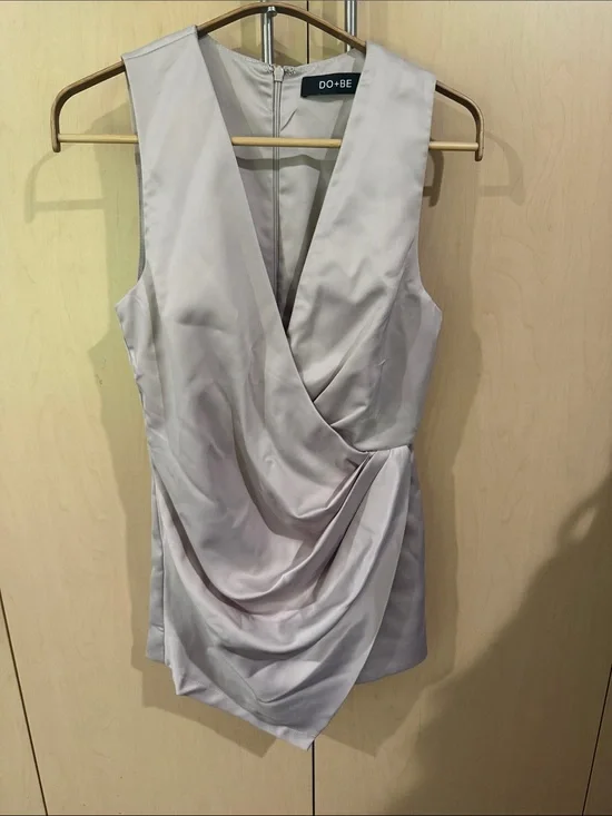 DO+BE Sleeveless elegant Draped Satin V-Neck Romper in golden cream.