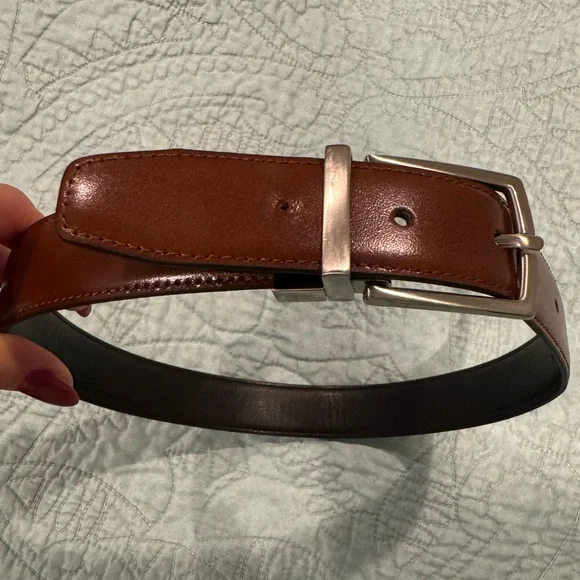 Reversible black/brown leather belt with silver-tone buckle, size stamped 24/60