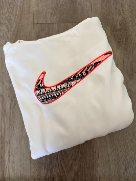 Nike White Sweatshirt with Neon Coral-Outlined Patterned Swoosh