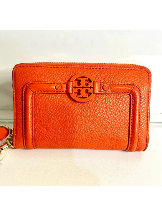 Tory Burch Amanda zip-around wallet featuring vibrant orange pebbled leather.