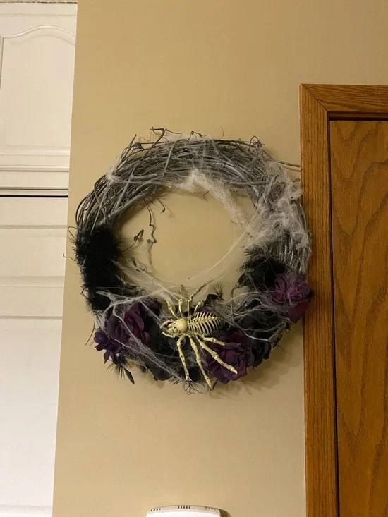 Halloween wreath with spider skeleton, flowers and cobwebs