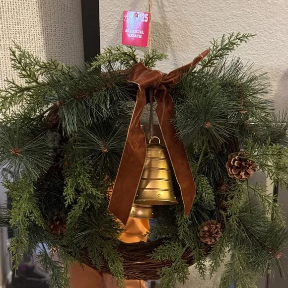Elegant Holiday Wreath with Gold Bell and Brown Ribbon