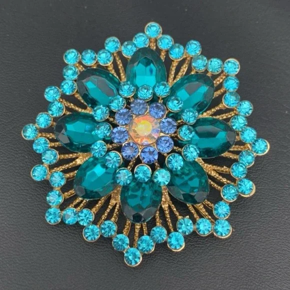 Gold tone and blue rhinestone brooch