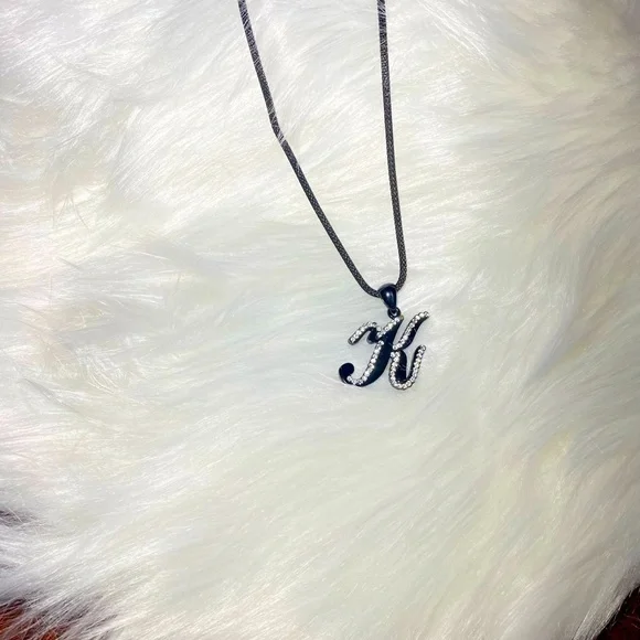 Necklace letter K in cursive‎ writing black with rhinestones on a black chain