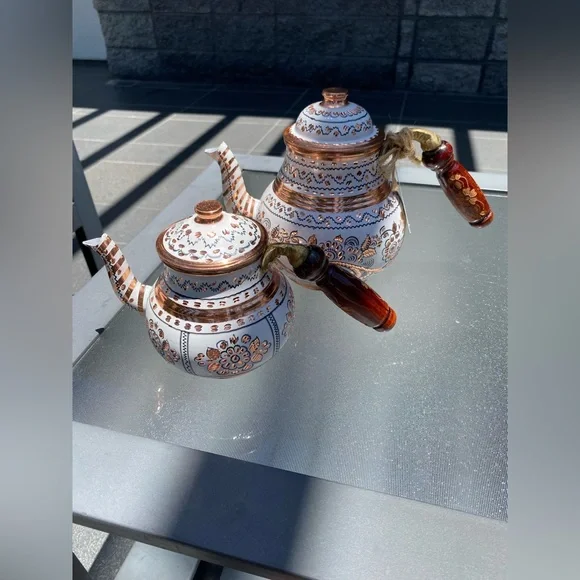 This handmade, white-painted Turkish copper teapot set features traditional
