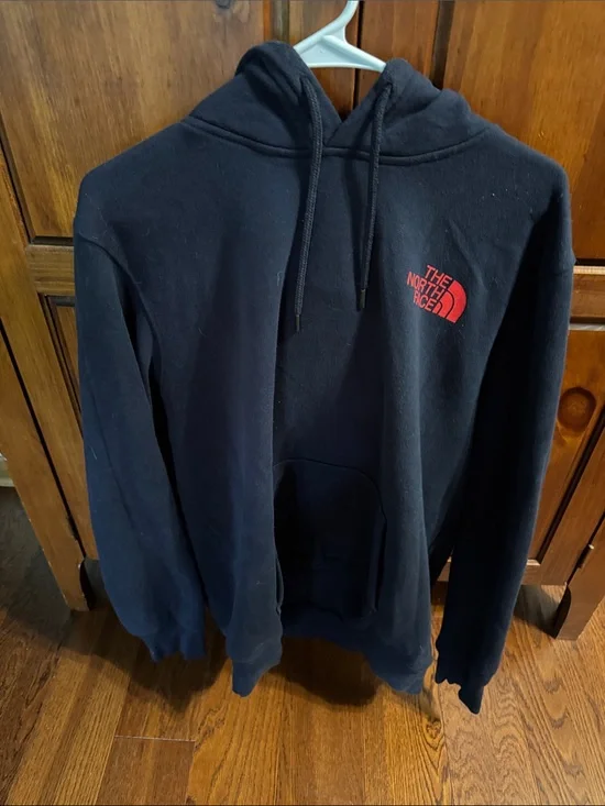 The North Face Blue Hoodie with Red Chest Logo