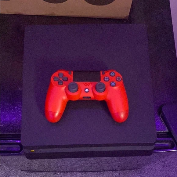 Black PlayStation 4 / red PlayStation controller