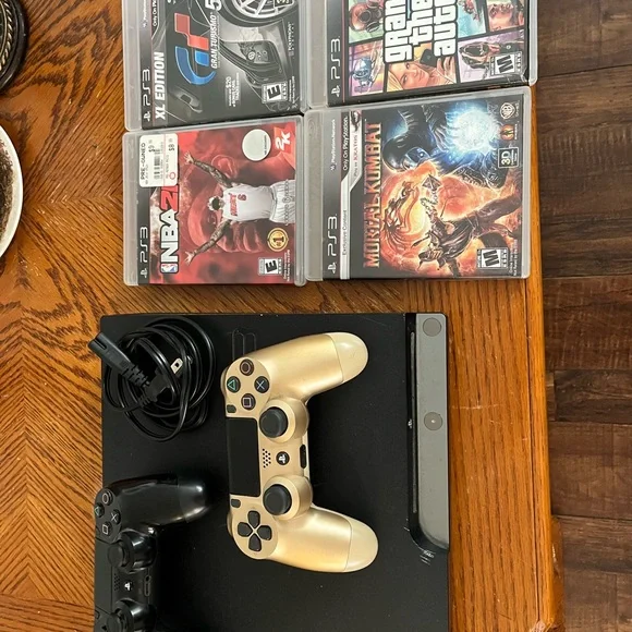 Sony Black and Gold Console with DualShock Controllers