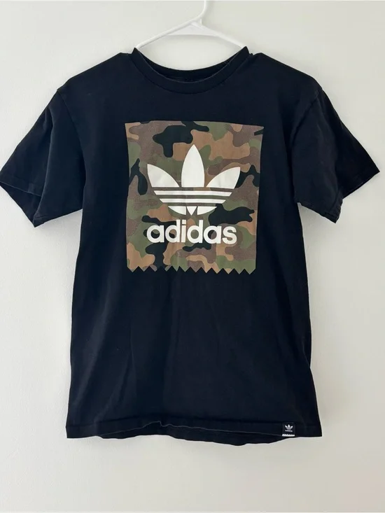 Adidas black t-shirt with white Adidas logo on camouflage background