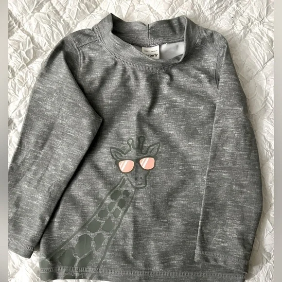 Swim shirt size 9m. Giraffe accent on the front. Like new Carter’s brand