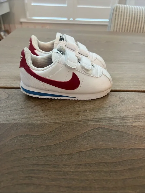 Nike Kids White Sneakers with Red Swoosh and Blue Sole Accent