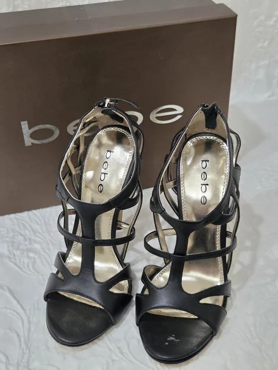 Bebe Black caged stiletto sandals featuring an open-toe design and a back zippe