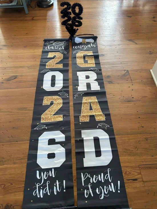 Graduation Decor.  Two black and gold banners and one tabletop “2026”.