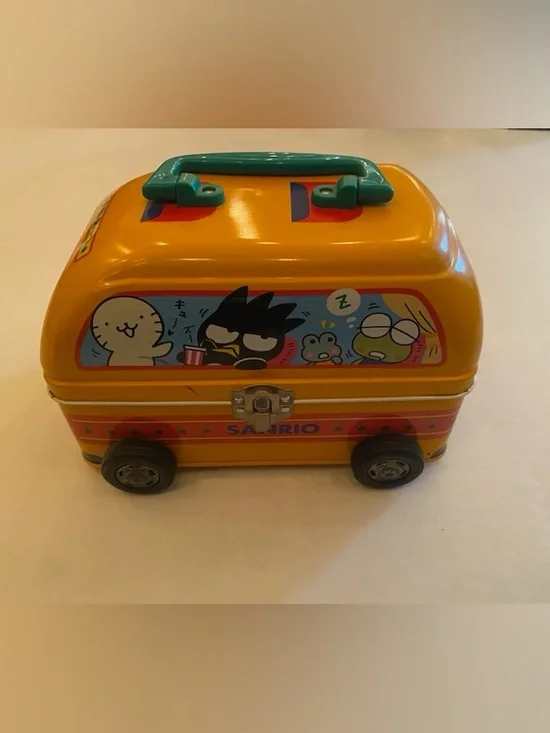 A Sanrio Yellow Toy Bus Metal Carry Case with Teal Handle